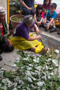 woman separating bark from stem for thread