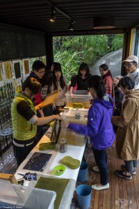 workshop members making paper