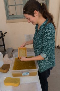 Workshop participant making fan palm paper on 2/20